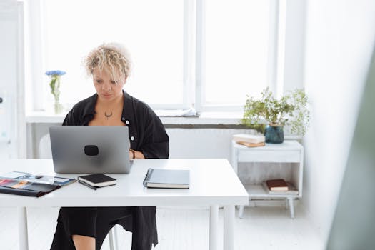 a person using a laptop in a cozy home office